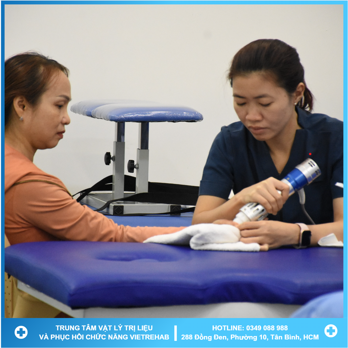 A therapist working with a patient on a rehabilitation machine with greenery in the background